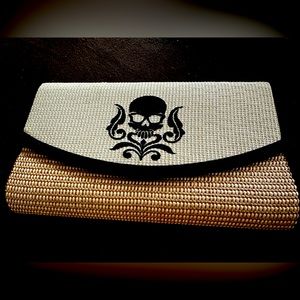 Stylish clutch purse with skull design.